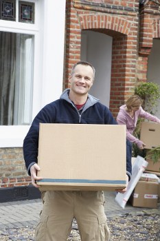 Moving van and packed boxes during house removals in Wapping