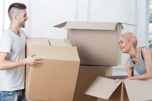 Professional movers handling furniture in a Wapping apartment