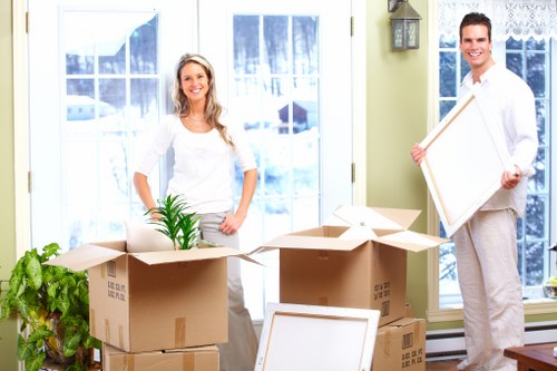 Employees preparing boxes and equipment for an office move in Wapping